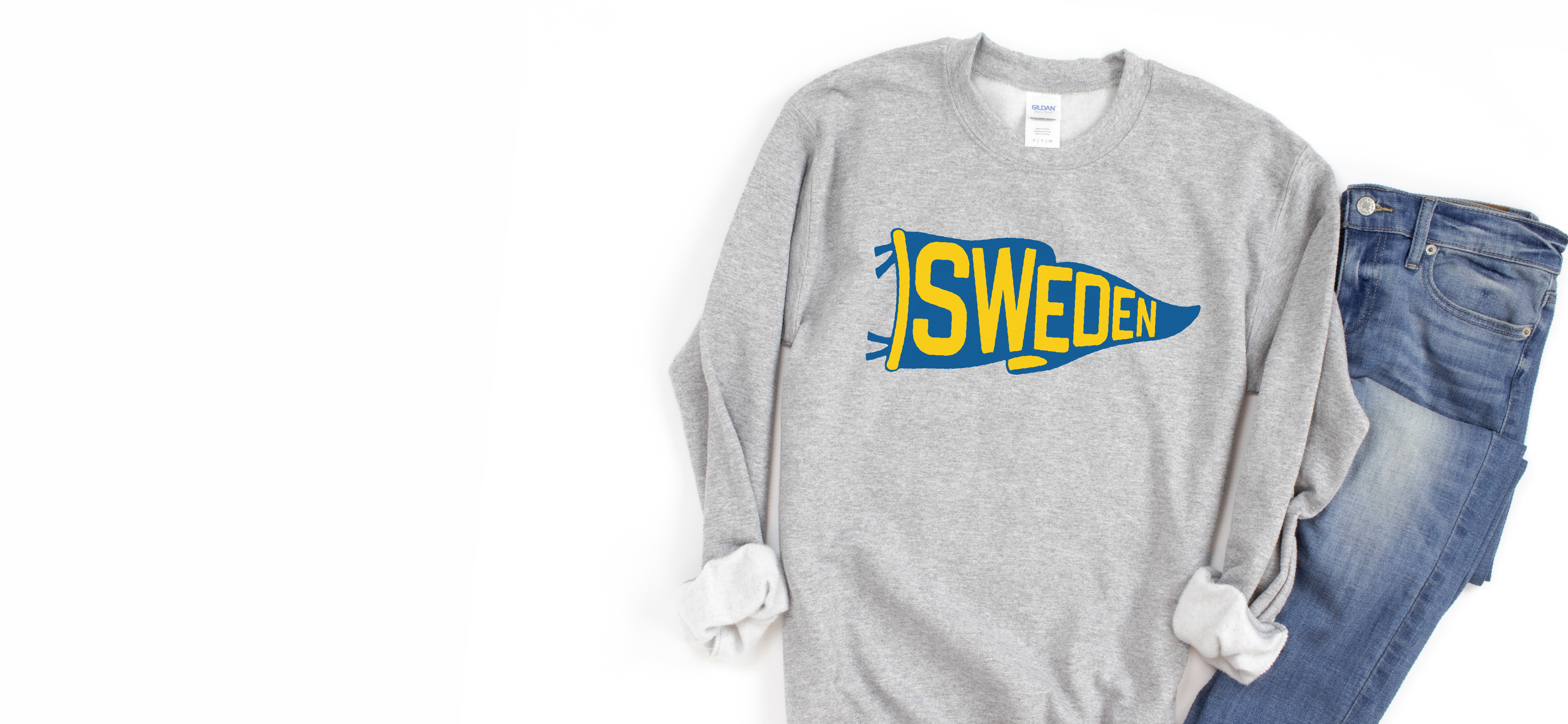 Gray sweatshirt with 'SWEDEN' print and blue jeans on a white background